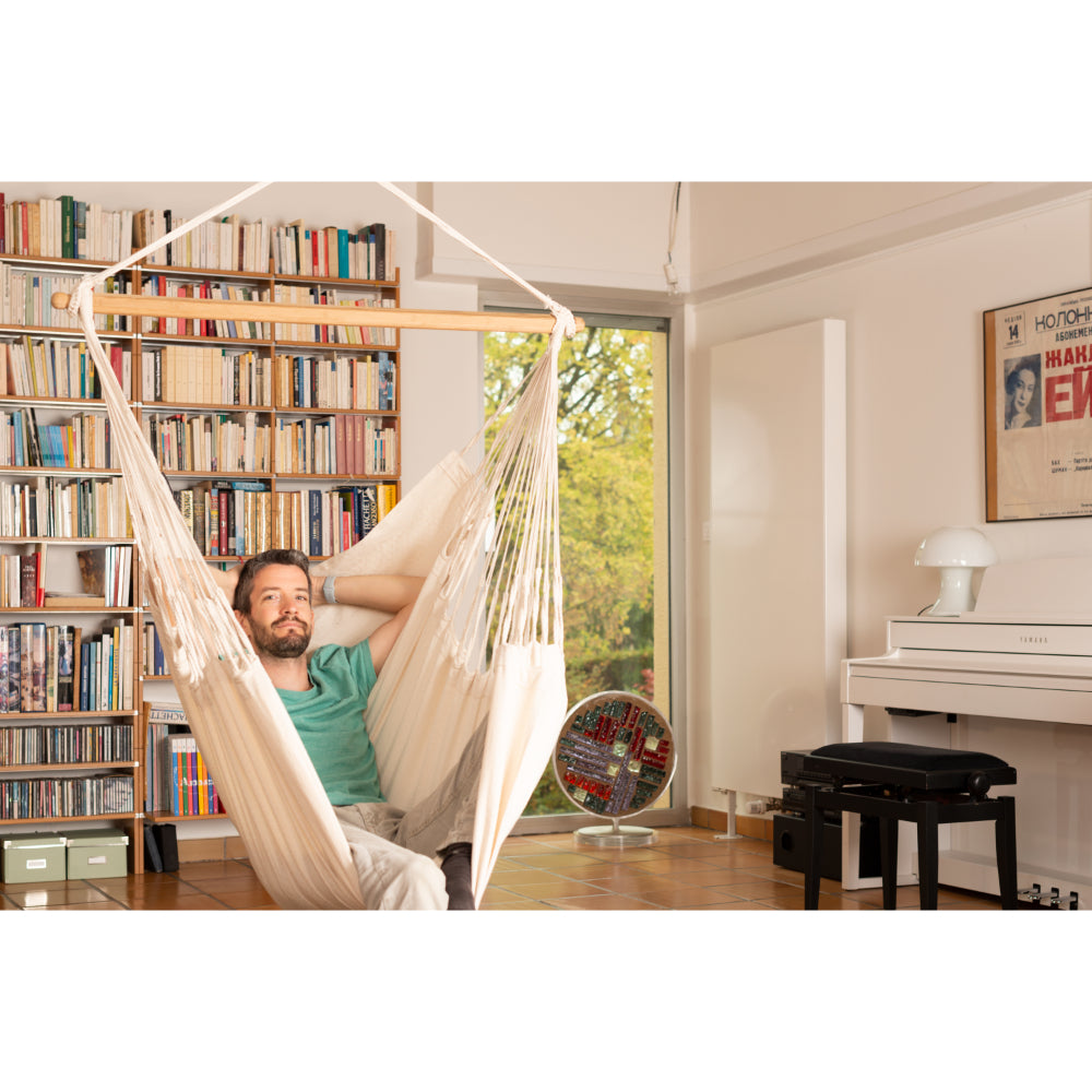 Man relaxing in hammock chair in library