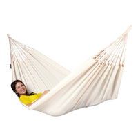Colombian white fabric hammock with woman relaxing in