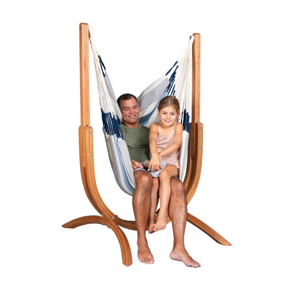 Blue and white hammock chair on curved wooden hammock frame
