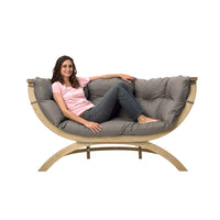 woman relaxing on outdoor cushioned wooden sofa