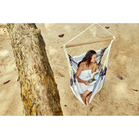 Woman resting in a hammock at the beach