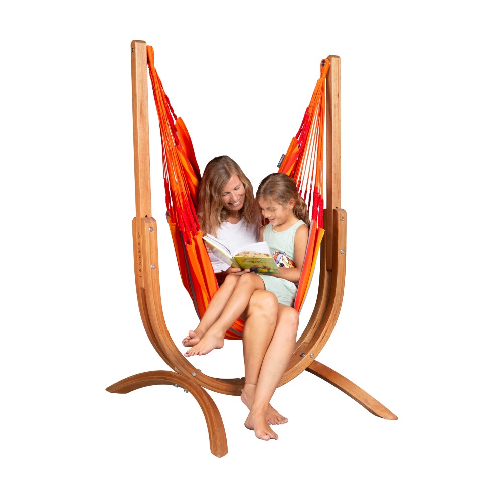 Mother and daugther reading a book in a hammock chair