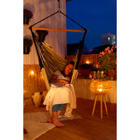 Woman sleeping outside at night in hammock chair