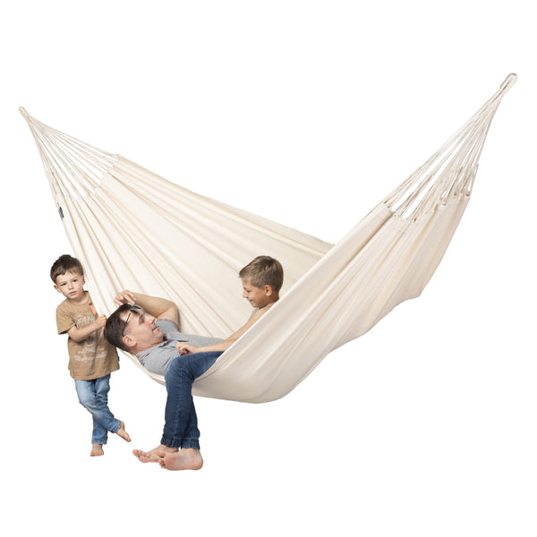Father and son playing together in large white hammock
