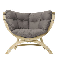 A curved wooden lounge chair with a thick, tufted gray cushioned seat and backrest