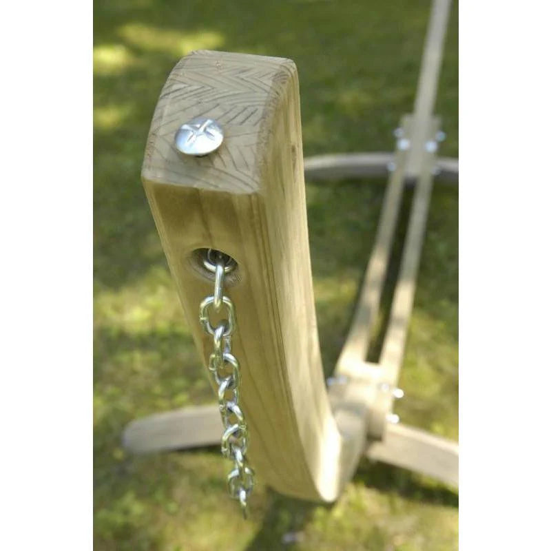 Wooden swing seat with metal chain on a grassy background