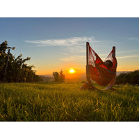 Hammock sitting in park in front of sunset