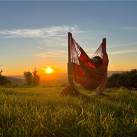 Hammock sitting in park in front of sunset