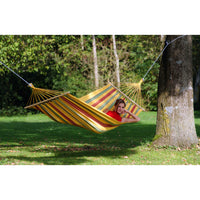 yellow colourful hammock hung from large tree