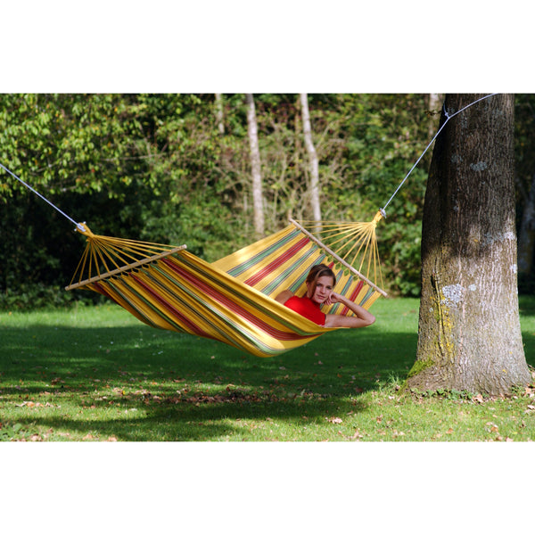 yellow colourful hammock hung from large tree