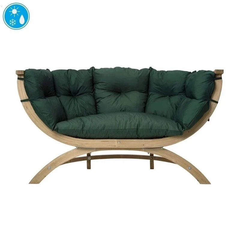 A curved wooden outdoor lounge chair with thick, tufted dark green cushions.