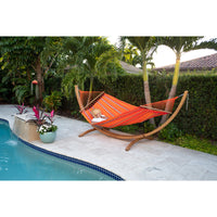Wooden hammock stand and fabric hammock poolside