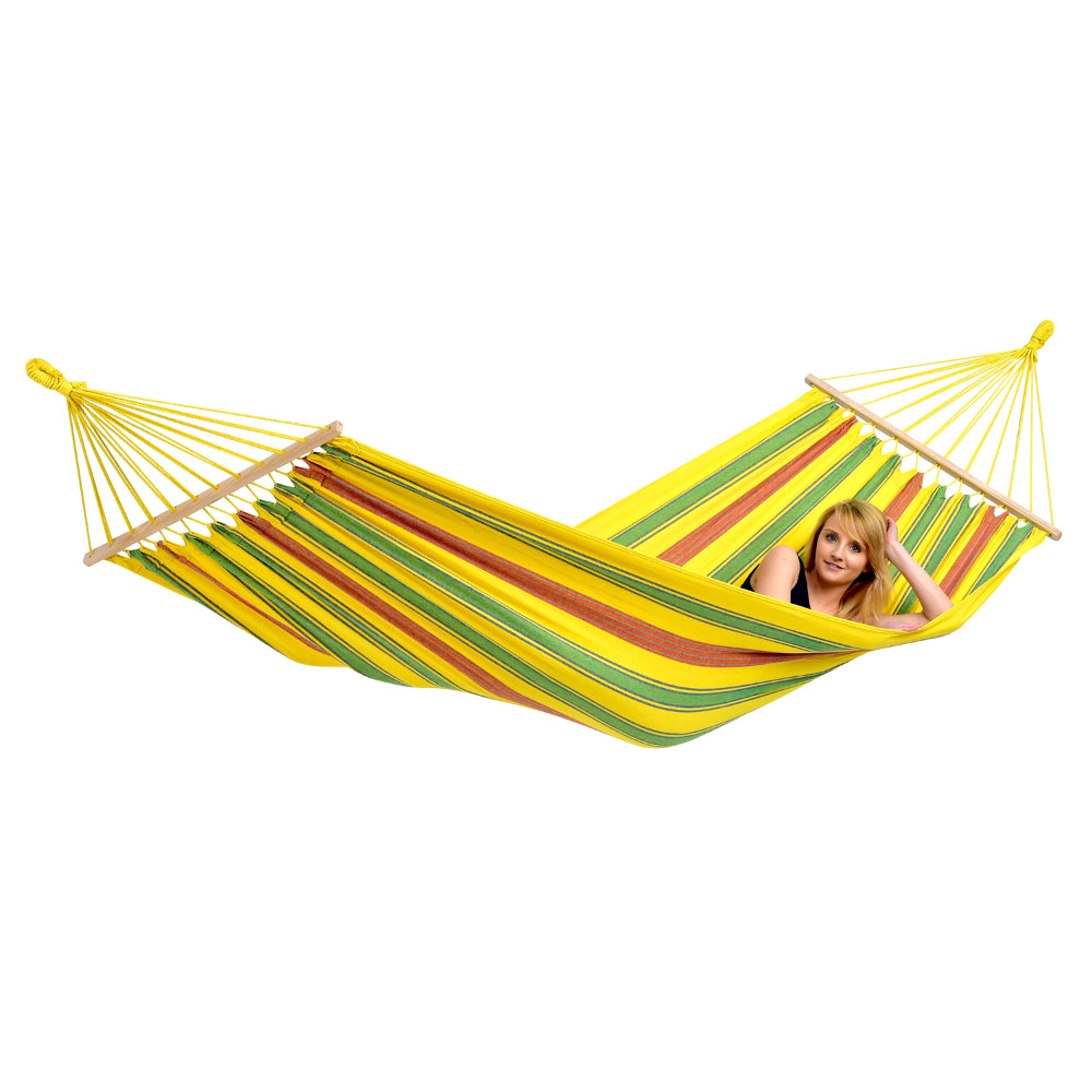 Woman relaxing in colourful yellow hammock