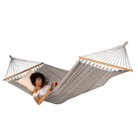 Young women reading in a spreader bar hammock