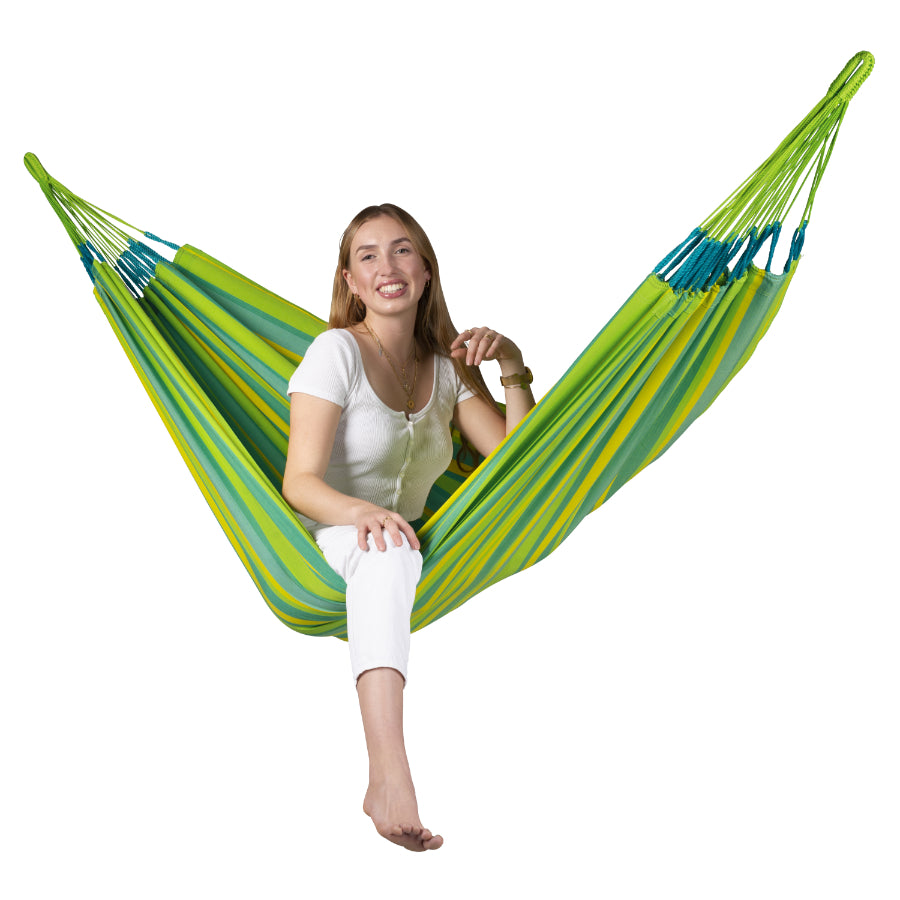 Young woman sitting in a colourful Colombian hammock