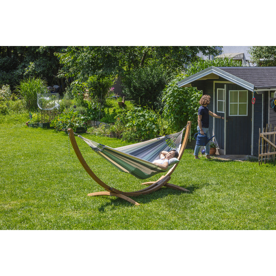 Hammock on stand on lawn in garden