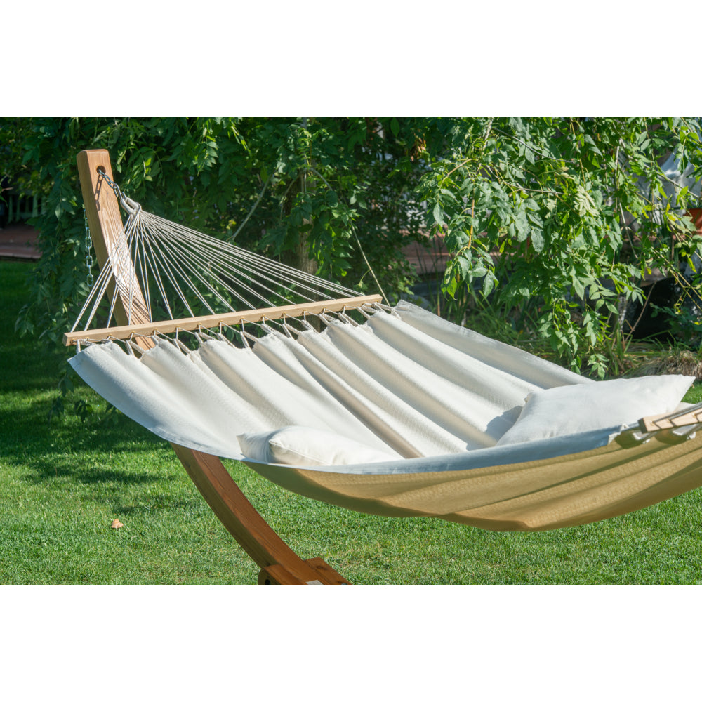 wooden hammock stand and white hammock outside in garden