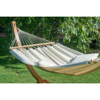 wooden hammock stand and white hammock outside in garden
