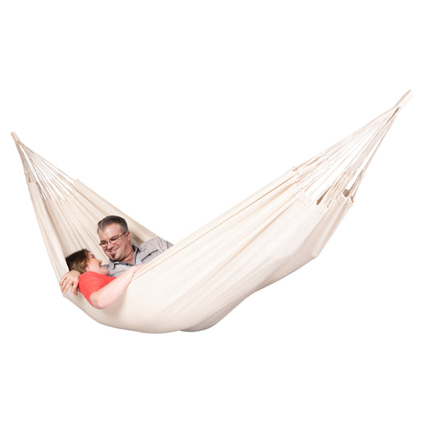 Couple resting in a double size white cotton hammock